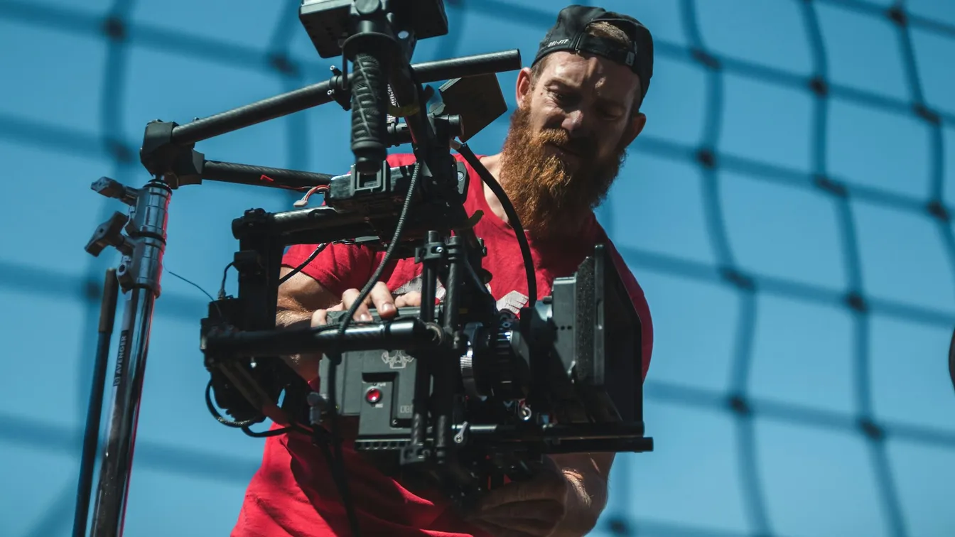 a man with a beard is holding a camera