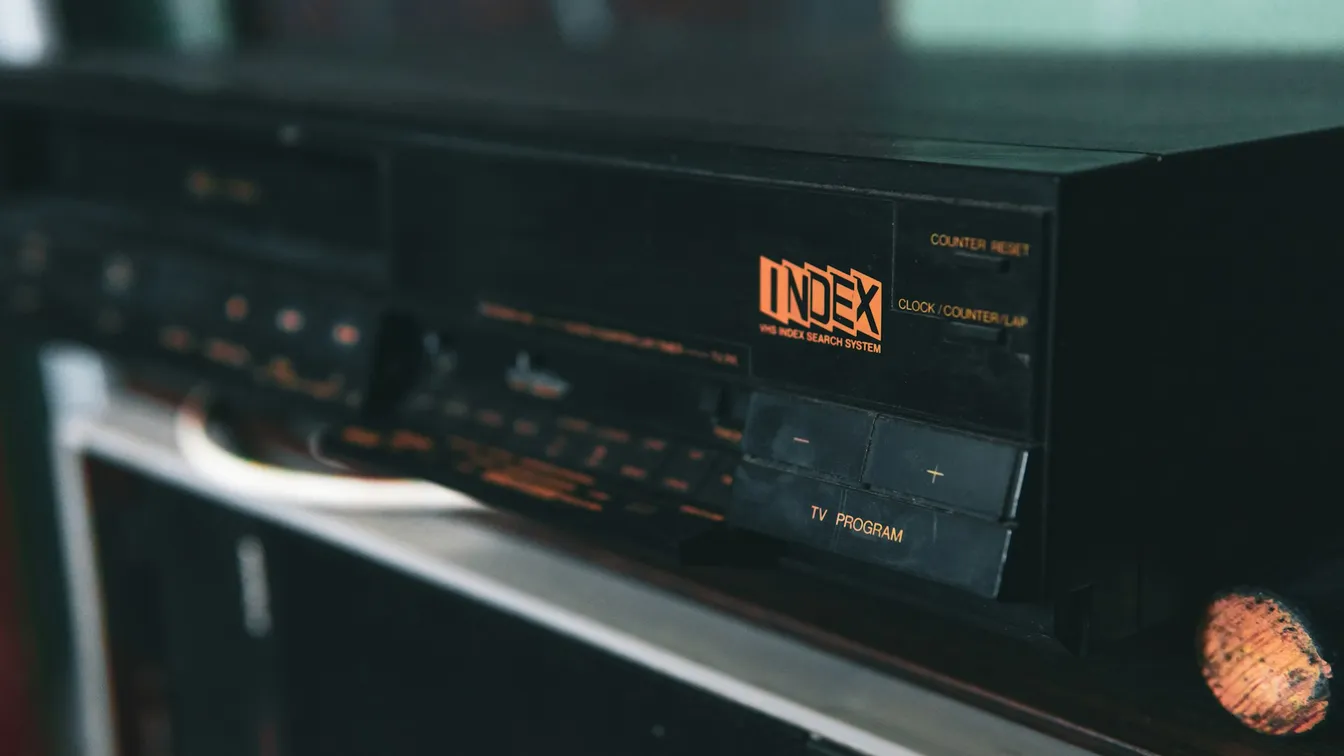 an old cd player sitting on top of a shelf