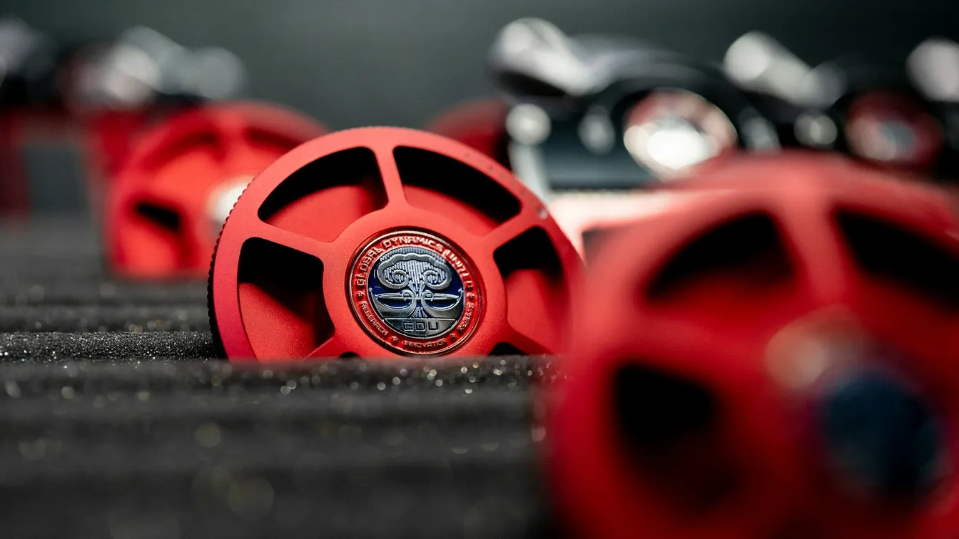 a group of red and black wheels on a black surface